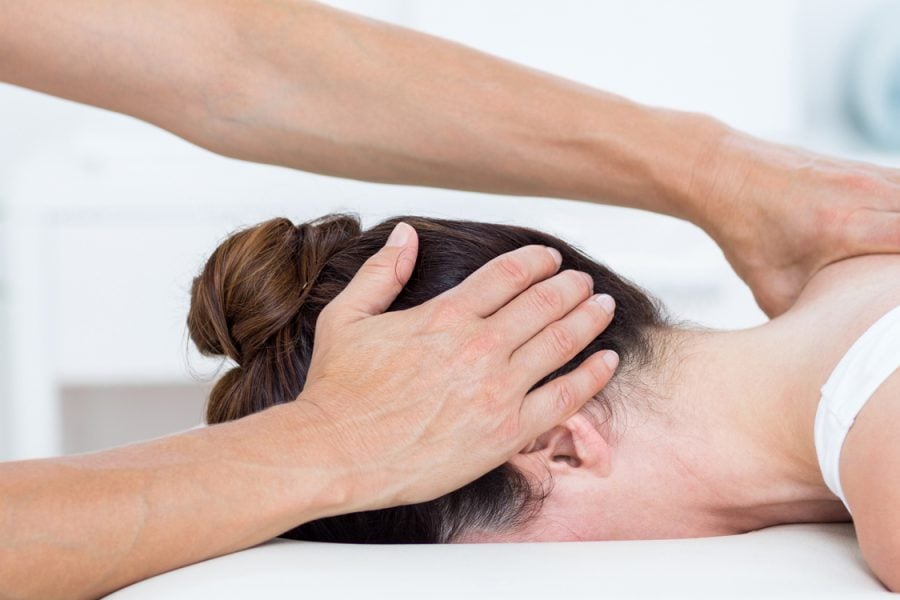 physiotherapist doing neck massage in medical office